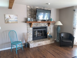 Relax in this inviting living room with a fireplace, flat-screen TV, and comfortable seating for socializing.