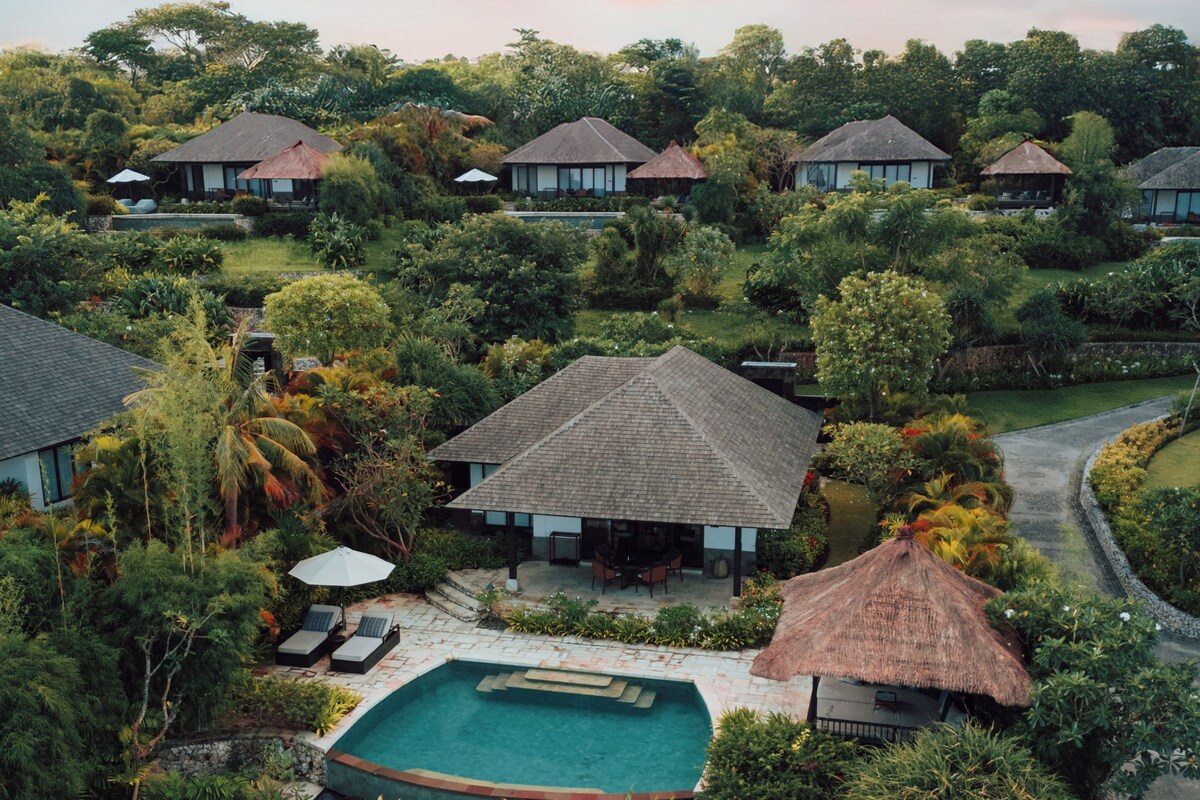 A resort with multiple bungalow-style buildings surrounded by lush greenery.