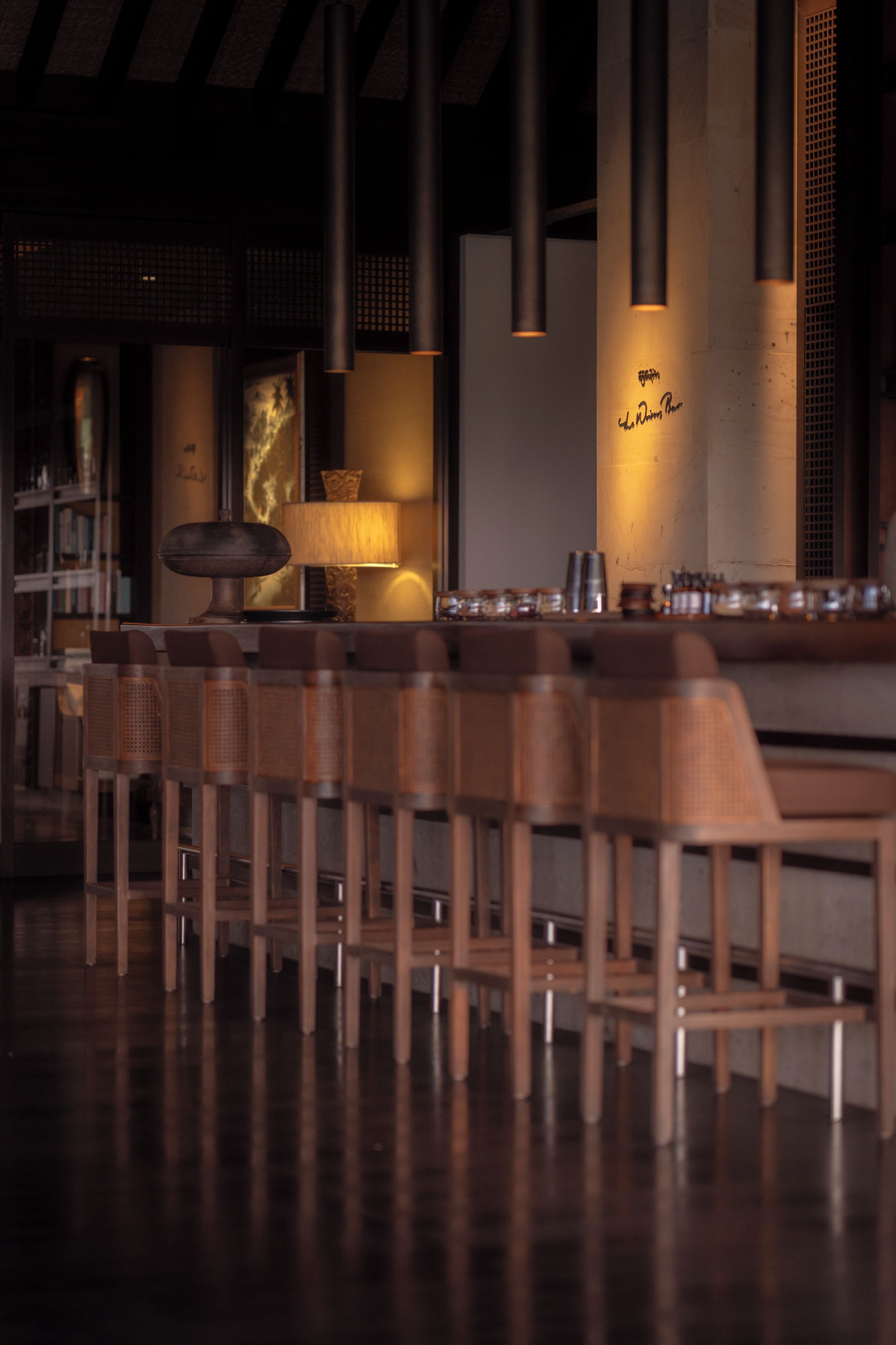 A bar area with wooden chairs and a bar counter.