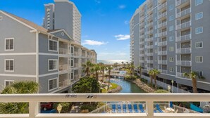 A hotel with multiple floors, a swimming pool, and a view of the ocean. - Myrtle Beach | Family Beach Retreat | Pool + Beach | 2BR (Myrtle Beach)
