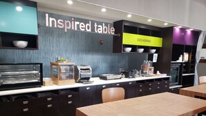 A cafe with a counter, a display for 'Inspired table', and a 'Good Morning' sign.