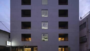 A modern multi-story building with evenly spaced windows and a flat facade.