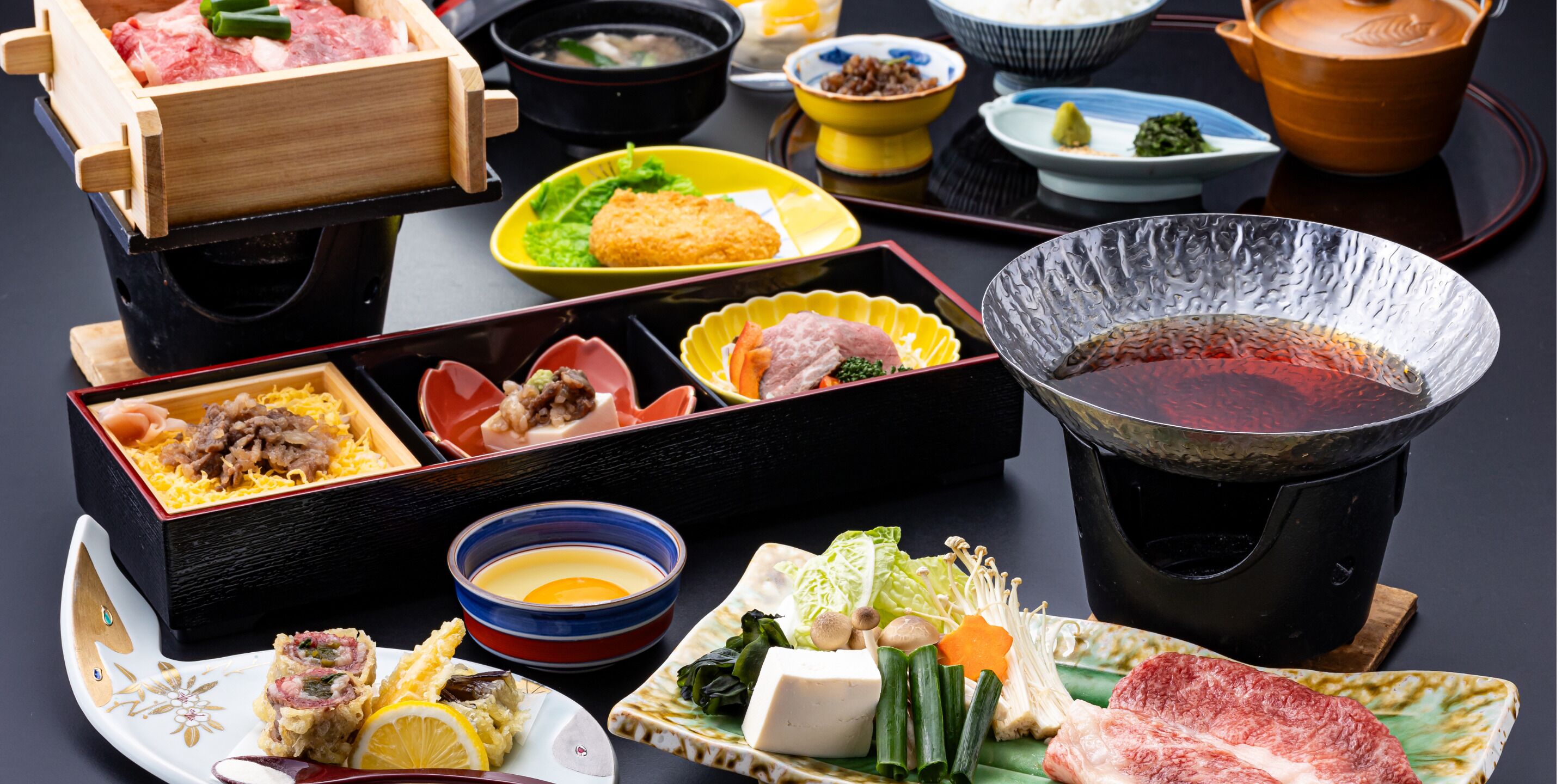 A variety of dishes and a hot pot setup, likely indicating a dining experience.