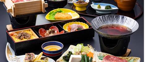 A variety of dishes and a hot pot setup, likely indicating a dining experience.