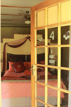 A room with a bed, a ceiling fan, and a door with a number and a fruit symbol. - Cherry Lane Self Catering and BB - Romantic Honeymoon Suite for 2 Bloemfontein (Bloemfontein)