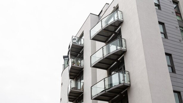 Ein modernes Gebäude mit mehreren Balkonen und großen Fenstern.