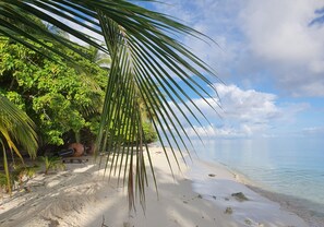 On the beach, white sand, sun-loungers, beach umbrellas