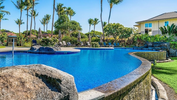 A swimming pool with lounge chairs and palm trees. - Fairway S Waikoloa J21 2 Bedroom Villa by RedAwning (Waikoloa)