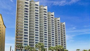 A high-rise hotel with multiple balconies and a clear blue sky. - Gulfside 0702 at Hidden Dunes - 1149893 (Miramar Beach)