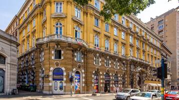 A historic building with multiple stories, large windows, and ornate architectural details.