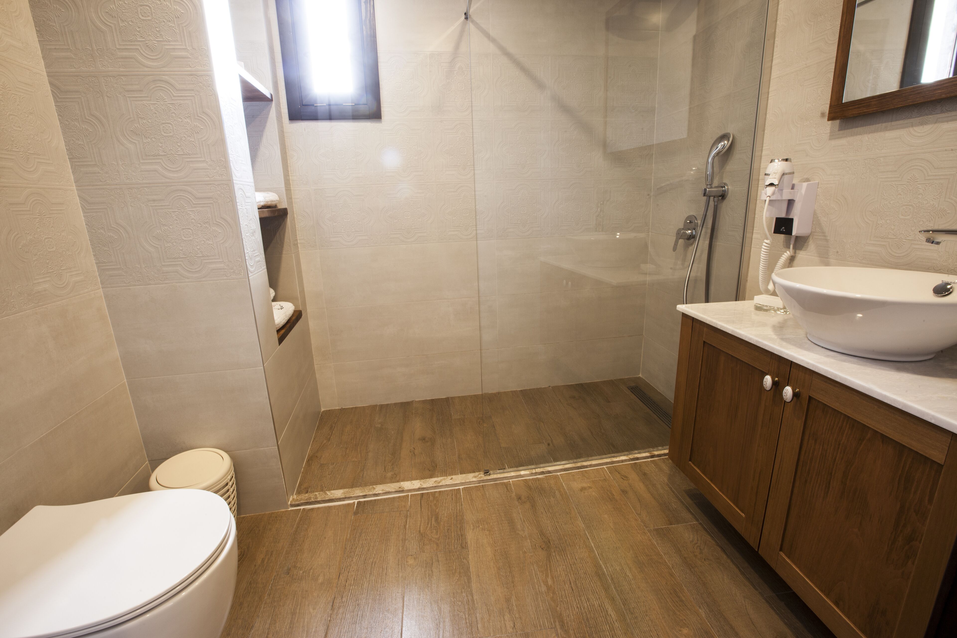 A bathroom with a toilet, a sink, and a shower.