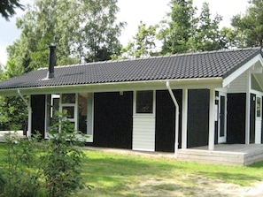 A single-story house with a covered porch, a chimney, and a small front yard. - 6 Person Holiday Home in Silkeborg (Silkeborg)