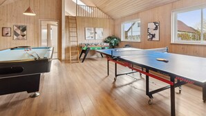 A wooden-paneled room with pool tables, a foosball table, and a ping pong table. - 4 Star Holiday Home in Bagenkop (Sydlangeland)