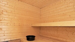 A sauna room with wooden walls and a bench. - 4 Star Holiday Home in Humble (Sydlangeland)