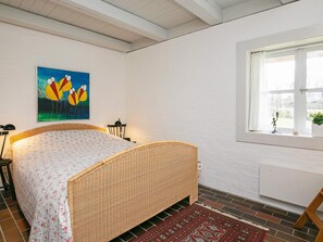 A room with a bed, a window, a painting, and a radiator. - 4 Star Holiday Home in Asperup (Middelfart)