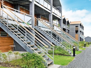 A modern building with multiple levels, outdoor stairs, and a gravel pathway. - 4 Star Holiday Home in Bogense (Bogense)