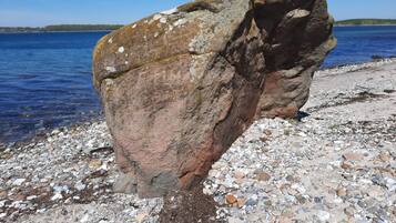 A large rock formation near a body of water.