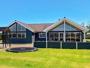 A two-story house with a large glass front and a small deck. - 5 Star Holiday Home in Sydals (Sydals)
