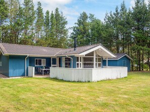 A two-story building with a covered porch, a chimney, and a fenced yard. - 6 Person Holiday Home in Oksbol-by Traum (Oksbol)