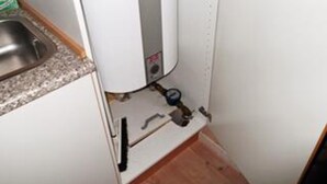 A kitchen with a built-in water heater, a sink, and a faucet. - 5 Star Holiday Home in Oksbol (Oksbol)