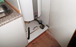 A kitchen with a built-in water heater, a sink, and a faucet. - 5 Star Holiday Home in Oksbol (Oksbol)