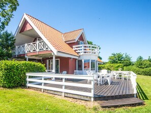 A two-story house with a balcony and a deck.