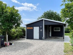 A small, dark-colored building with a sign reading "Casa Kruise 17" and a door. - 6 Person Holiday Home in Sydals (Sydals)