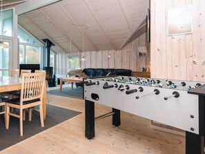 A room with a foosball table, wooden furniture, and a large window. - 5 Star Holiday Home in Harboore (Harboore)