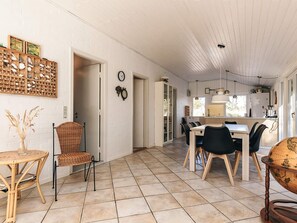A spacious kitchen with a dining area, white walls, and a tiled floor. - 6 Person Holiday Home in Albaek (Aalbaek)