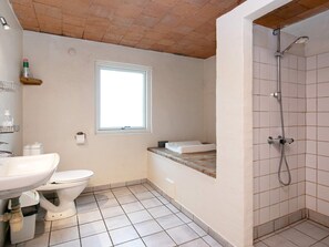 A bathroom with a toilet, sink, and shower.