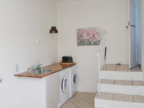 A compact kitchen with a washing machine, a sink, and a wooden countertop. - Peaceful Holiday Home in Thisted near Sea (Nordborg)