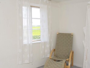 A room with a window, a wooden chair, and a wall-mounted item. - Peaceful Holiday Home in Thisted near Sea (Nordborg)