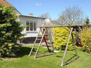 A wooden swing set in a grassy yard with a house in the background. - Peaceful Holiday Home in Thisted near Sea (Nordborg)