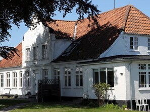 A two-story building with a red-tiled roof, white walls, and multiple windows. - Peaceful Holiday Home in Thisted near Sea (Nordborg)
