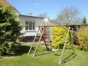 A wooden swing set in a grassy yard with a house in the background. - Peaceful Holiday Home in Thisted near Sea (Nordborg)