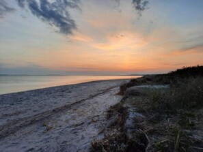 A beach with a sandy path leading to the water, surrounded by vegetation. - 5 Star Holiday Home in Sydals (Sydals)