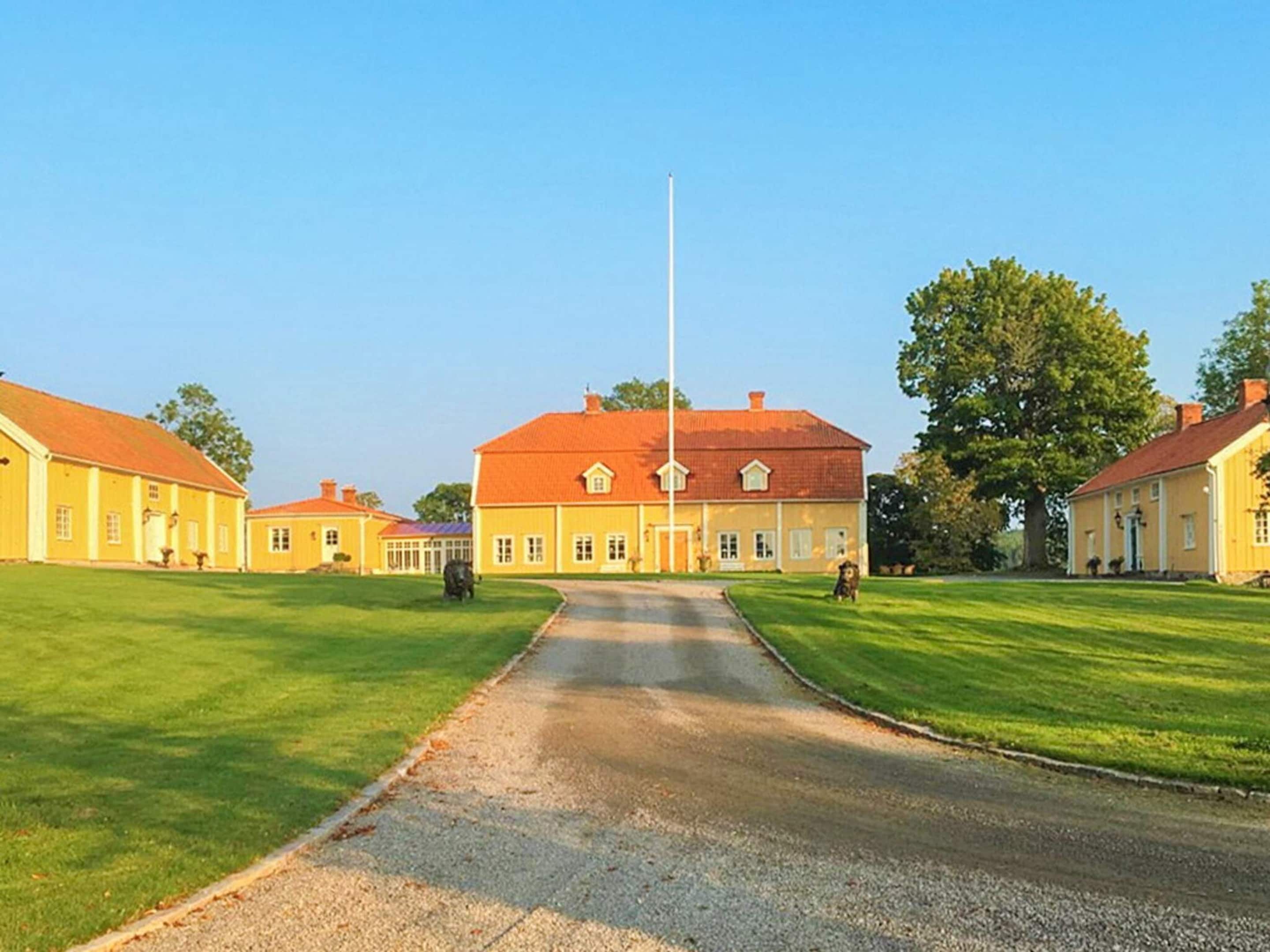 A large building with a central flagpole, surrounded by well-maintained lawns and smaller buildings.