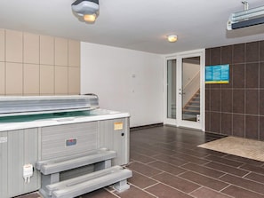 A spa area with a hot tub, a staircase, and a tiled floor. - Gorgeous Holiday Home in Ebeltoft with Hot Tub (Ebeltoft)