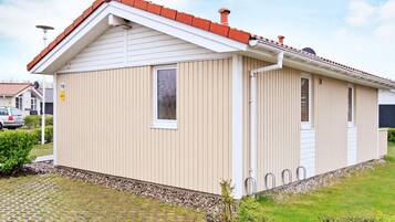 A single-story building with a pitched roof, a small window, and a door.