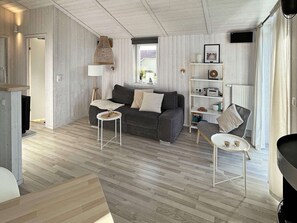 Relax in this stylish living room with a grey sofa, coffee table, and bookshelf.