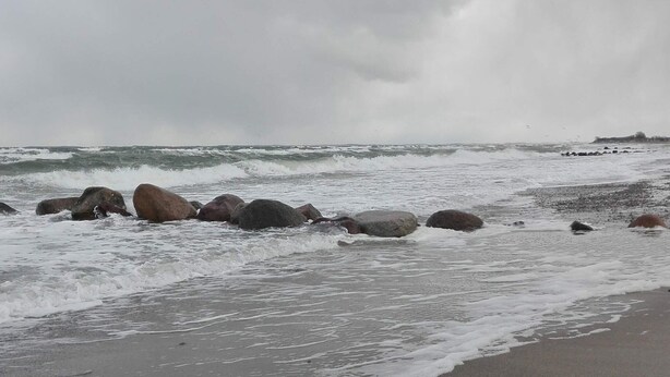 A beach with large rocks and waves. - 4 Star Holiday Home in Otterup (Otterup)