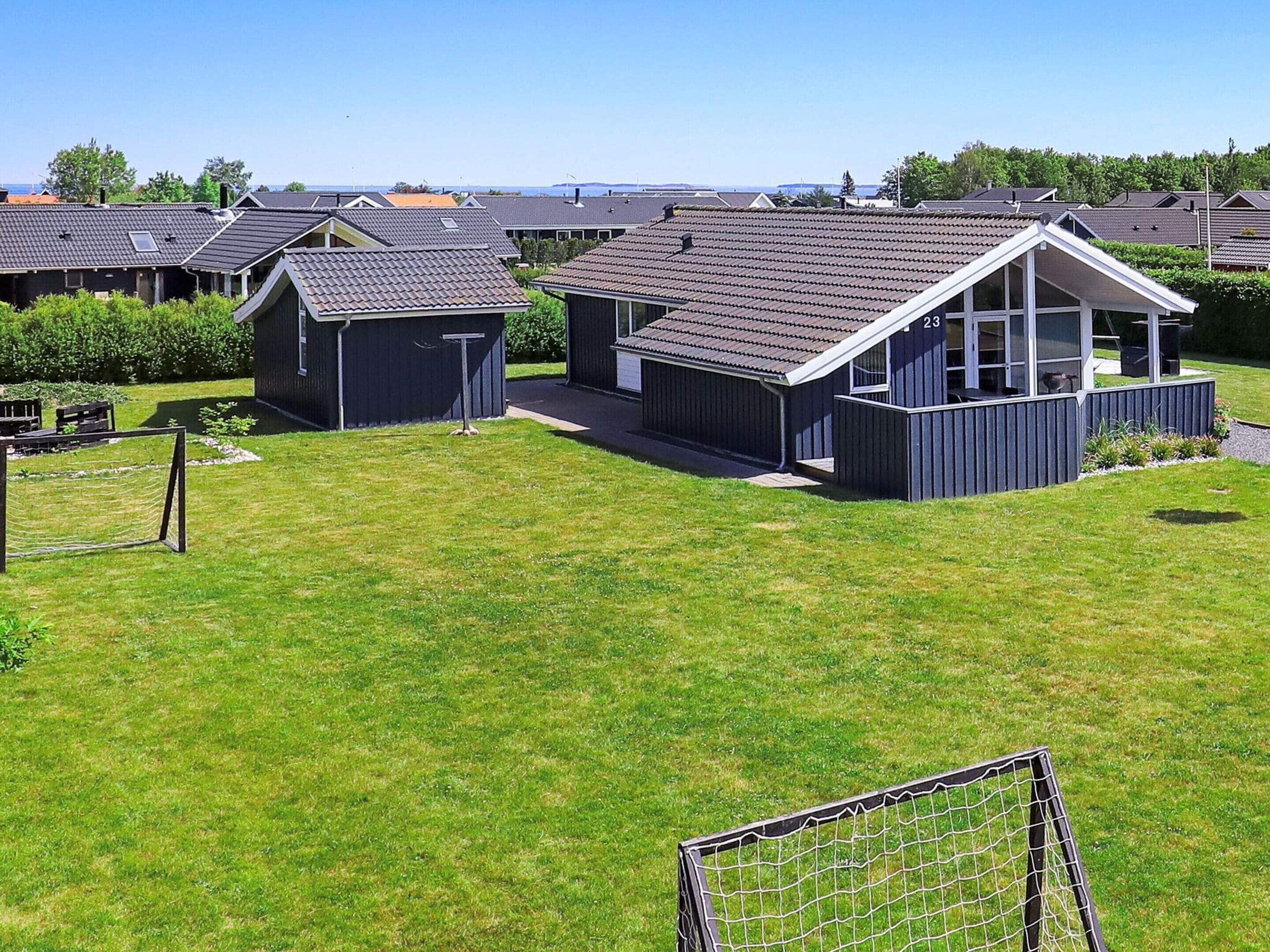 A residential area with multiple houses, each featuring a distinct architectural style with pitched roofs and large windows.