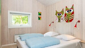 A bedroom with two beds, a window, and wall decorations. - 4 Star Holiday Home in Ebeltoft (Ebeltoft)