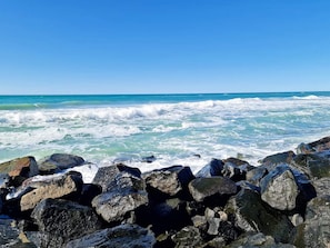 A rocky shoreline with waves crashing against the rocks.