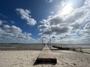A wooden pier leading to a beach with a clear sky and clouds. - 4 Star Holiday Home in Bjert (Bjert)