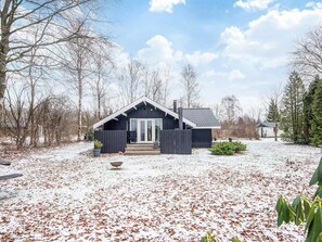 A cabin with a dark exterior, a front porch, and a snow-covered yard. - 6 Person Holiday Home in Toftlund (Toftlund)