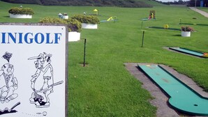 A golf course with a sign reading "INIGOLF" and illustrations of golfers. - 6 Person Holiday Home in Tranekaer-by Traum (Tranekaer)