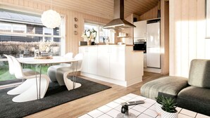 A modern kitchen with white cabinets, a central island, and a built-in oven. - 6 Person Holiday Home in Tranekaer-by Traum (Tranekaer)