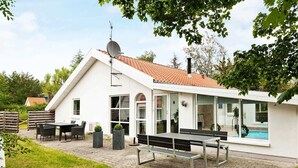 A white building with a sloped roof, a satellite dish, and a swimming pool. - 8 Person Holiday Home in Ebeltoft-by Traum (Ebeltoft)