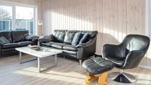 A modern living room with a leather sofa, a coffee table, and a leather armchair. - 4 Person Holiday Home in Borkop-by Traum (Borkop)